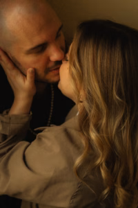 Close-up of a couple about to kiss, warm intimate lighting